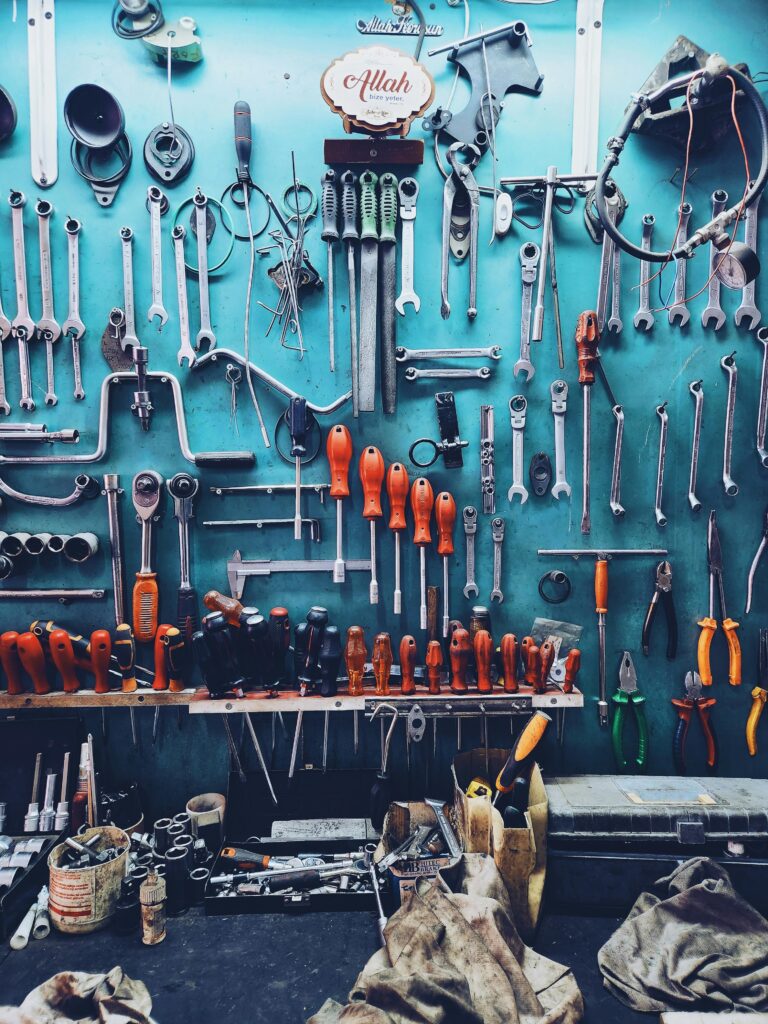 A neatly arranged collection of tools on a workshop wall, perfect for automotive or repair themes.